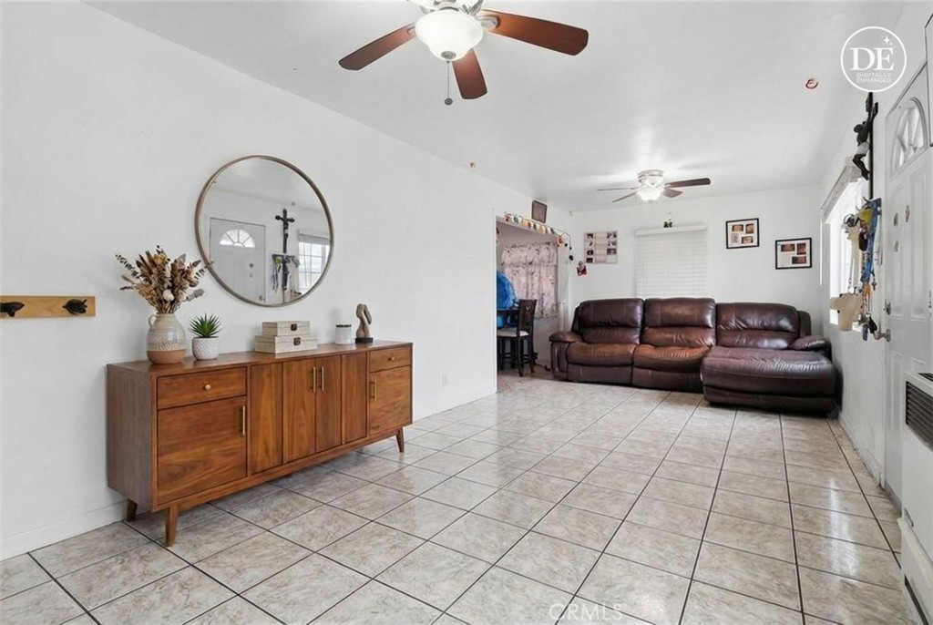 440 West Cherry Street Compton, CA 90222 - Photo 2 of 28 a living room with furniture a clock and a ceiling fan