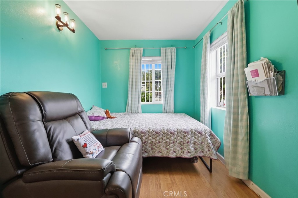 440 West Cherry Street Compton, CA 90222 - Photo 22 of 28 a bedroom with a bed and a chair