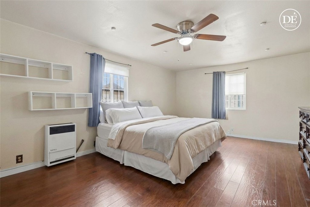 440 West Cherry Street Compton, CA 90222 - Photo 4 of 28 a bedroom with a large bed chandelier and a window