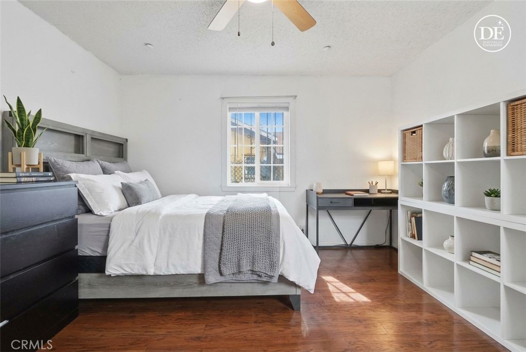 440 West Cherry Street Compton, CA 90222 - Photo 8 of 28 a spacious bedroom with a bed a table and painting on the wall
