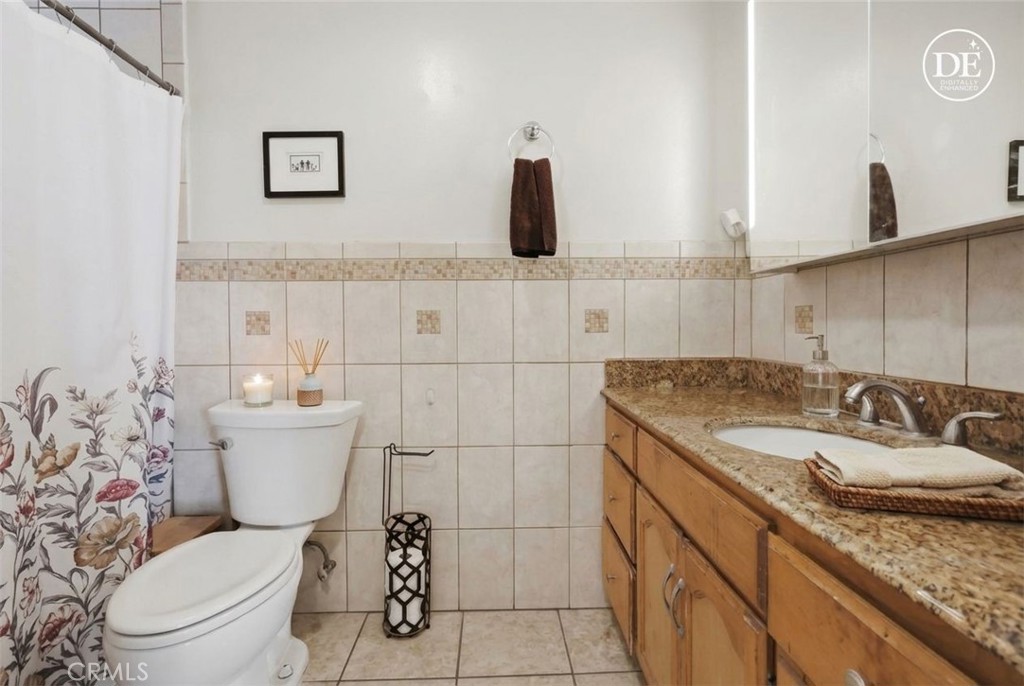 440 West Cherry Street Compton, CA 90222 - Photo 9 of 28 a bathroom with a granite countertop toilet sink and mirror