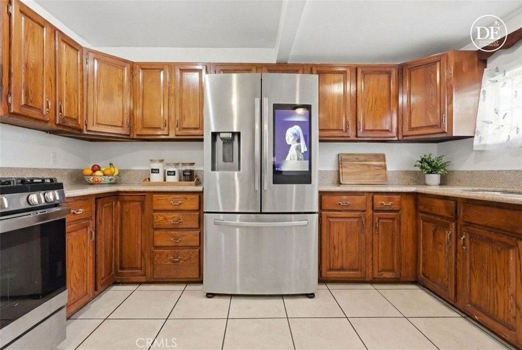 440 West Cherry Street Compton, CA 90222 - Photo 10 of 28 a kitchen with stainless steel appliances granite countertop a refrigerator and a sink