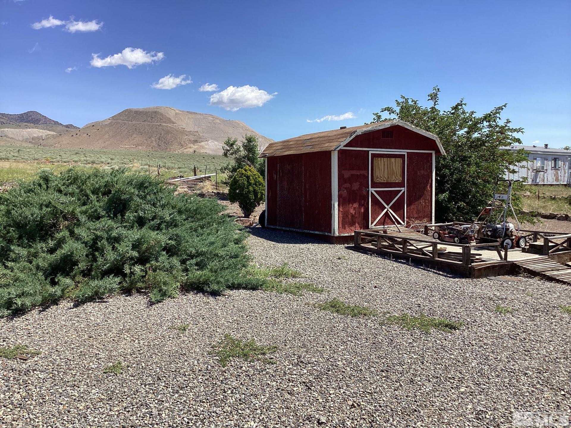 217 Territory Road Dayton, NV 89403 - Photo 12 of 15 a view of a barn with a yard