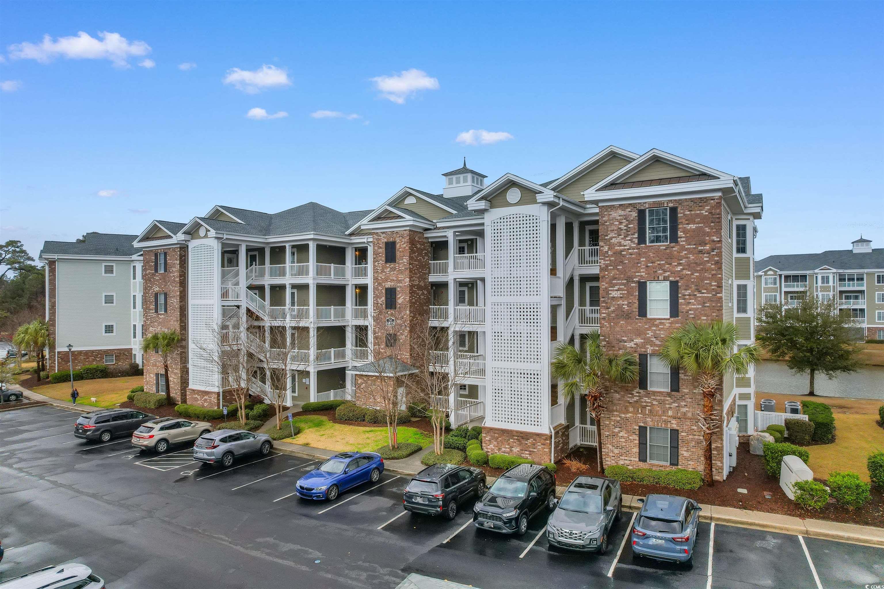 View of property with uncovered parking