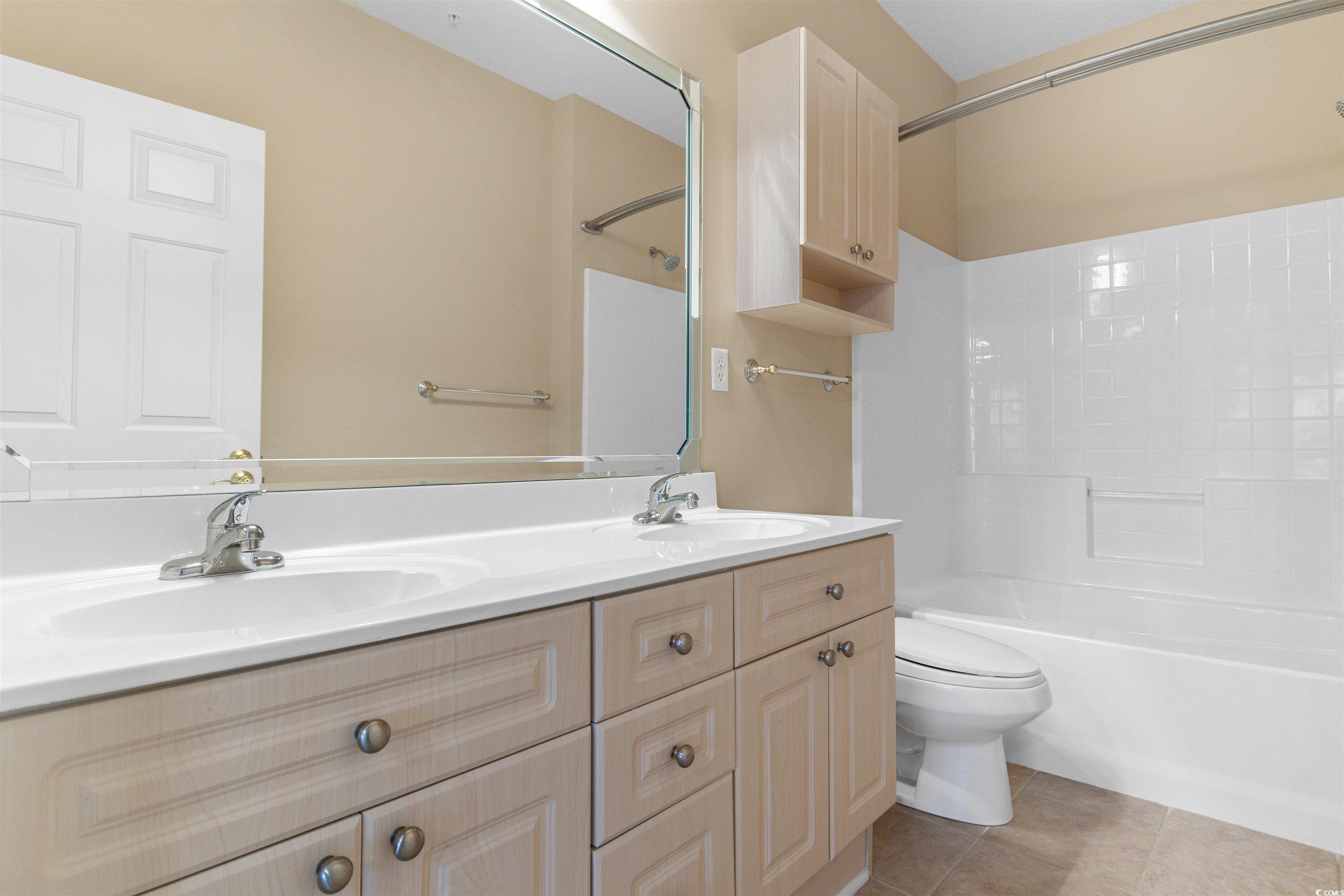 4875 Luster Leaf Circle, Unit 202 Myrtle Beach, SC 29577 - Photo 15 of 40 Full bathroom featuring double vanity, tile patter