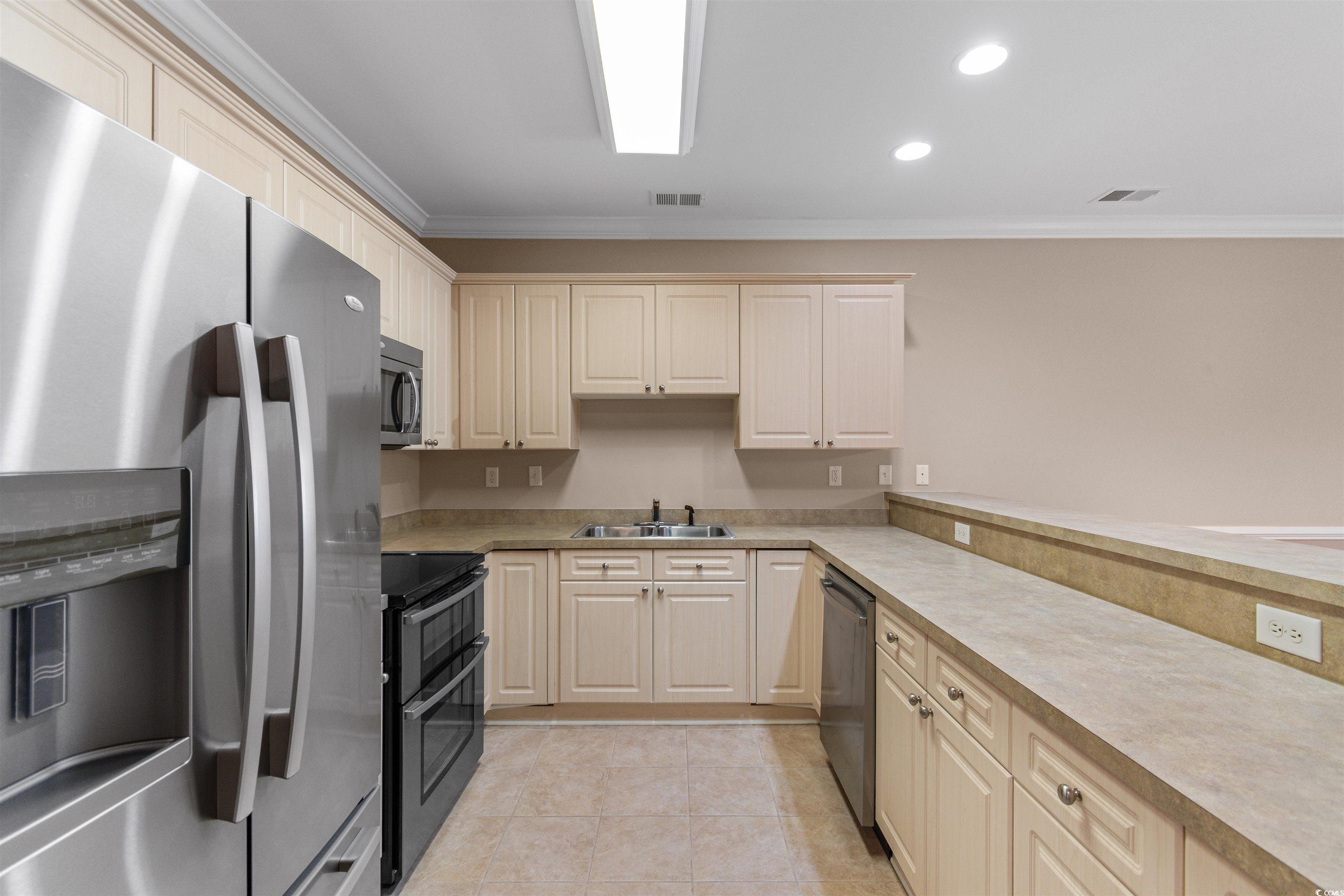 4875 Luster Leaf Circle, Unit 202 Myrtle Beach, SC 29577 - Photo 4 of 40 Kitchen featuring light tile patterned floors, vis