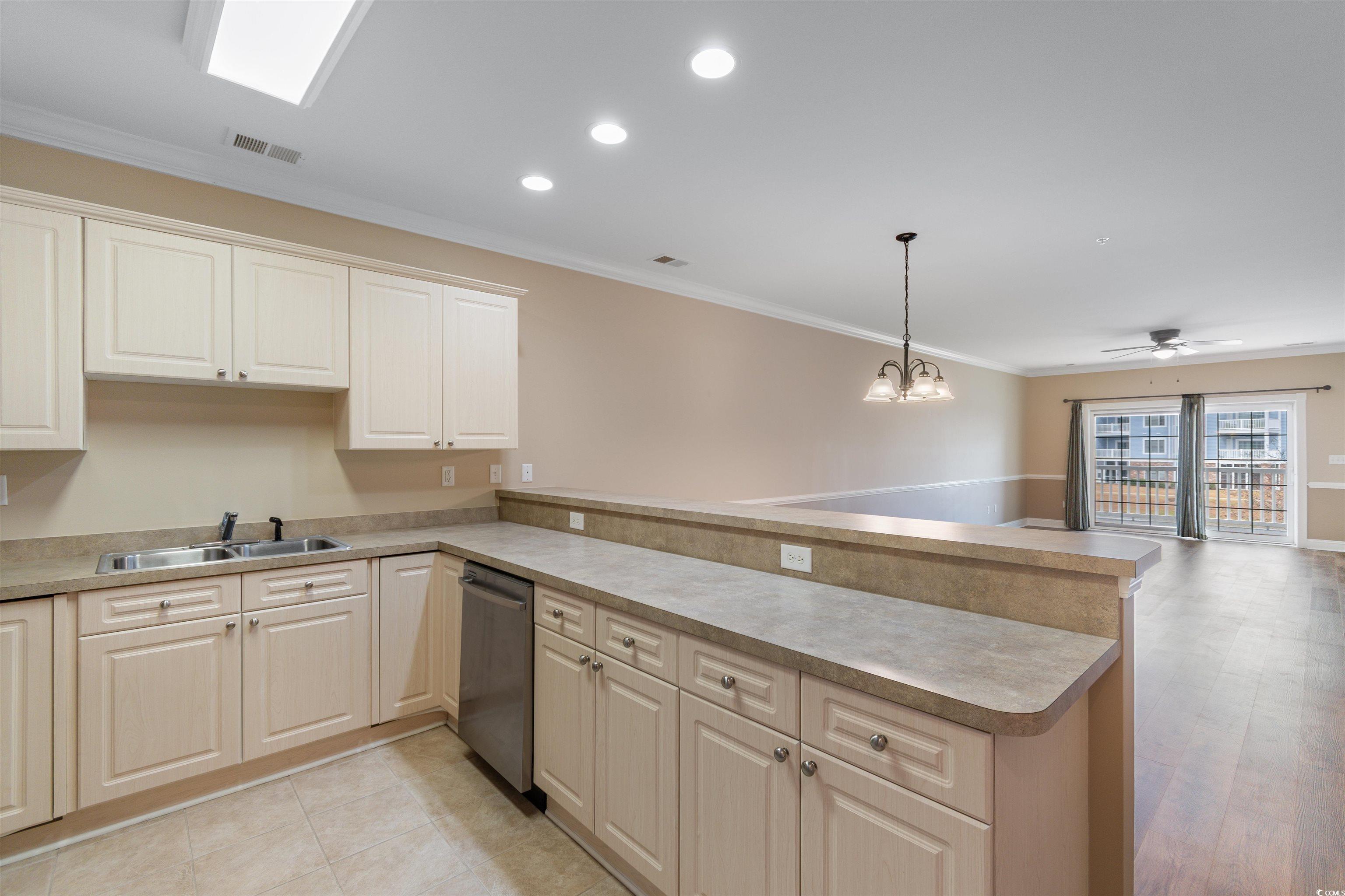 4875 Luster Leaf Circle, Unit 202 Myrtle Beach, SC 29577 - Photo 5 of 40 Kitchen featuring a peninsula, a sink, visible ven