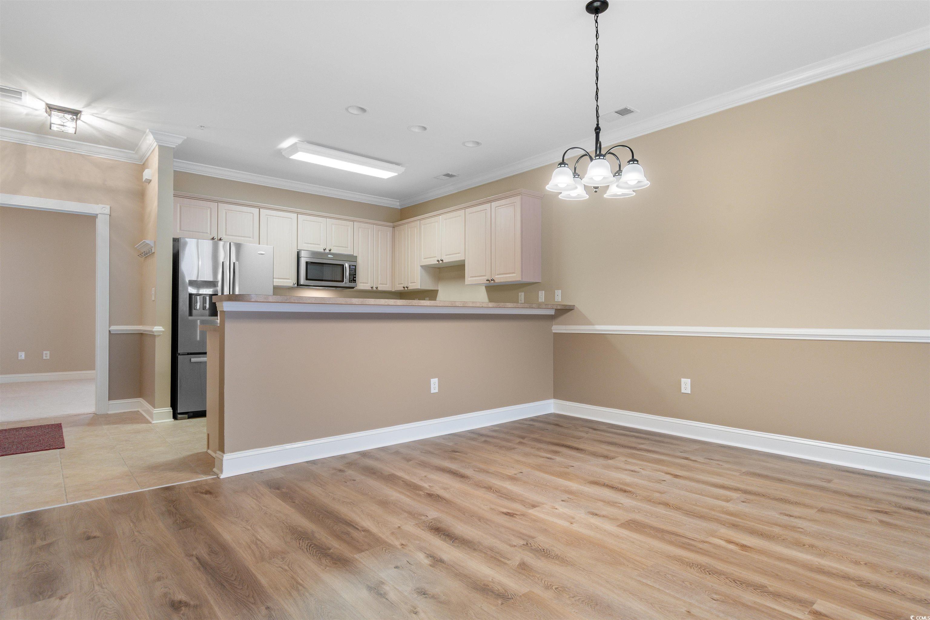 4875 Luster Leaf Circle, Unit 202 Myrtle Beach, SC 29577 - Photo 6 of 40 Kitchen featuring pendant lighting, a peninsula, a