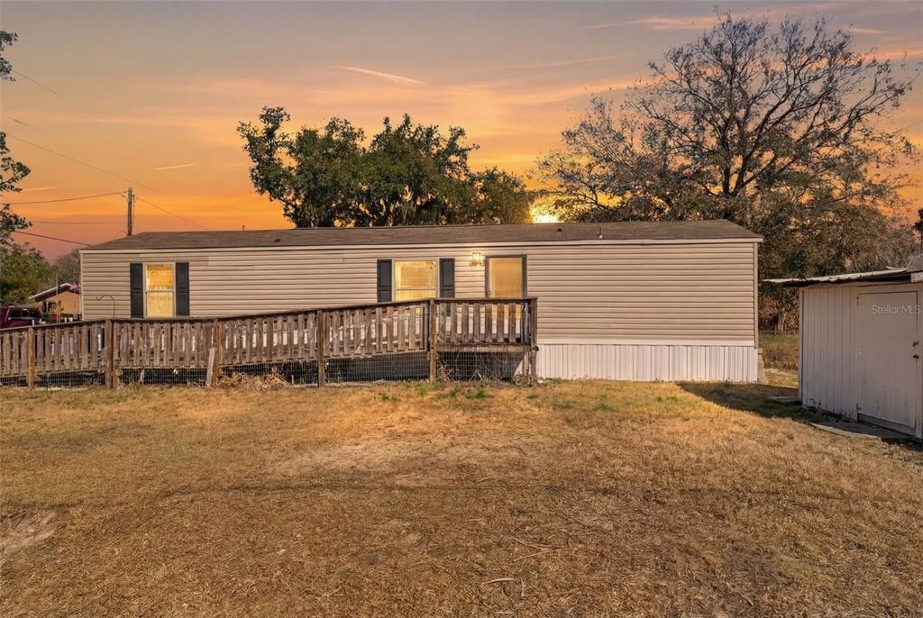 a view of a house with wooden floor and a yard