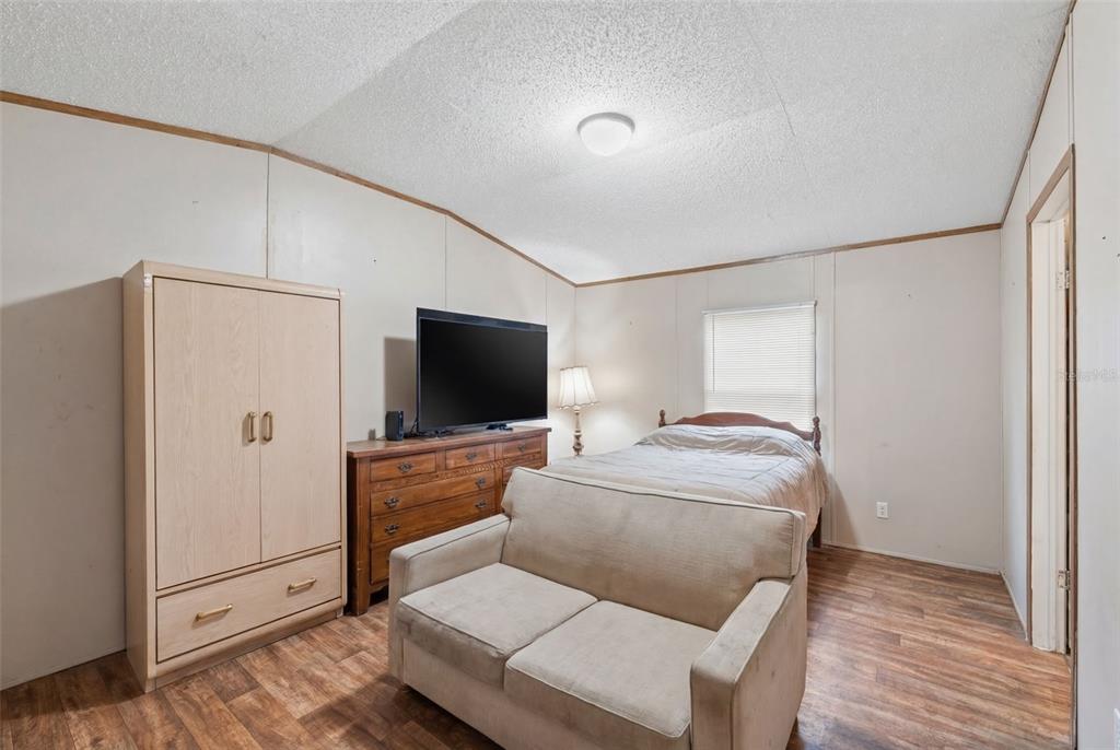 10501 East Patience Lane Inverness, FL 34450 - Photo 16 of 37 a bedroom with a bed and a flat screen tv