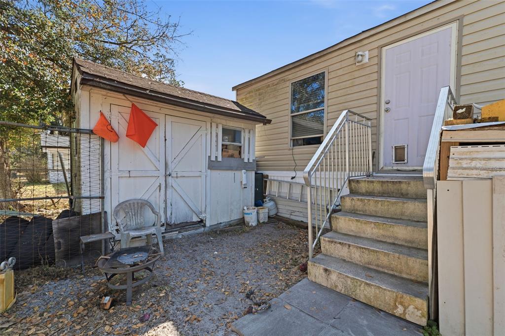 10501 East Patience Lane Inverness, FL 34450 - Photo 20 of 37 a backyard of a house with a large tree and wooden fence