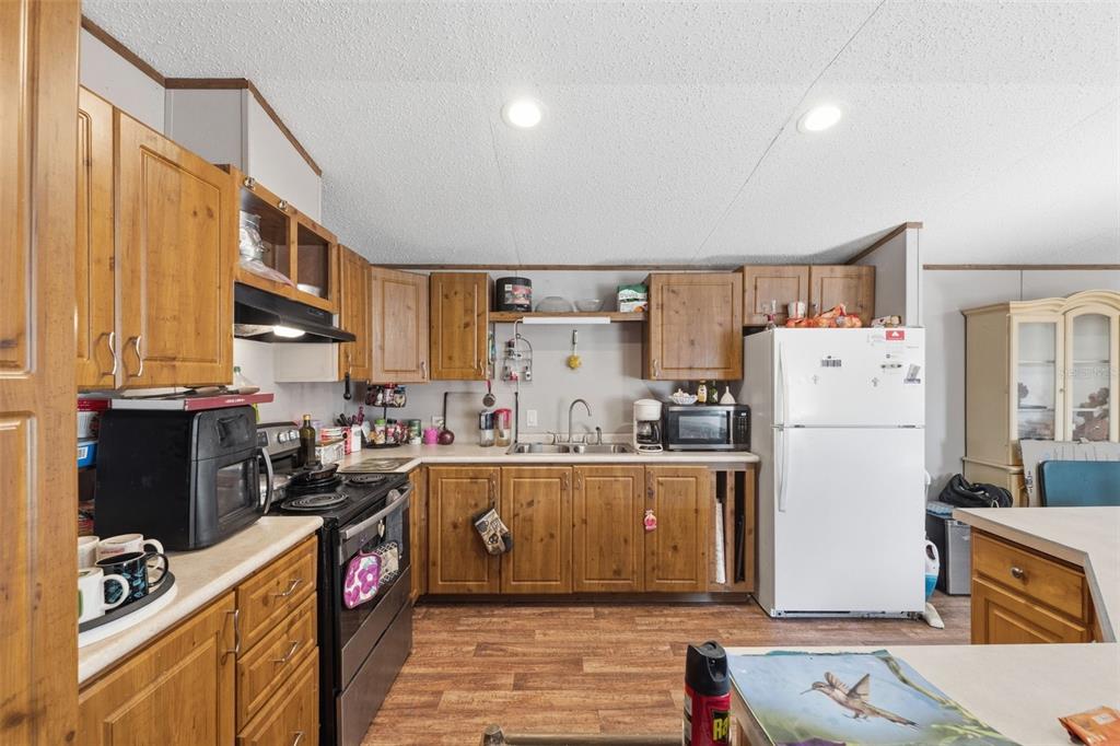 10501 East Patience Lane Inverness, FL 34450 - Photo 28 of 37 a kitchen with refrigerator and cabinets