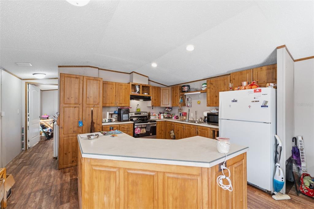 10501 East Patience Lane Inverness, FL 34450 - Photo 29 of 37 a view of a kitchen with furniture and a refrigerator