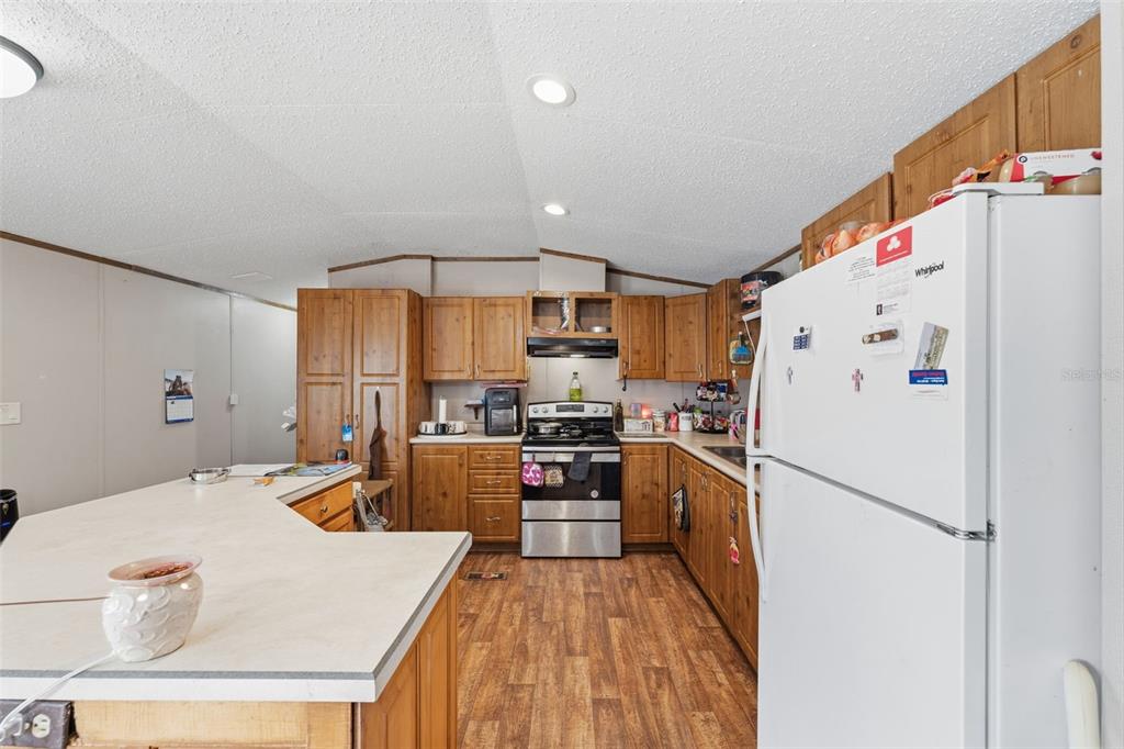10501 East Patience Lane Inverness, FL 34450 - Photo 30 of 37 a kitchen with refrigerator a stove and a sink