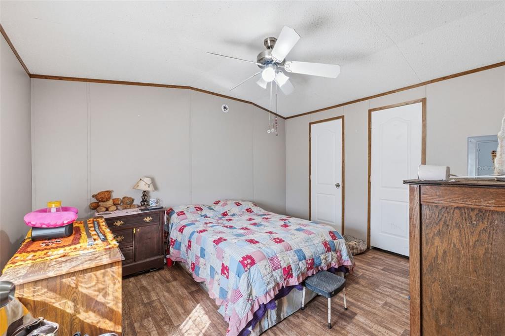 10501 East Patience Lane Inverness, FL 34450 - Photo 33 of 37 a bedroom with a bed and a chandelier