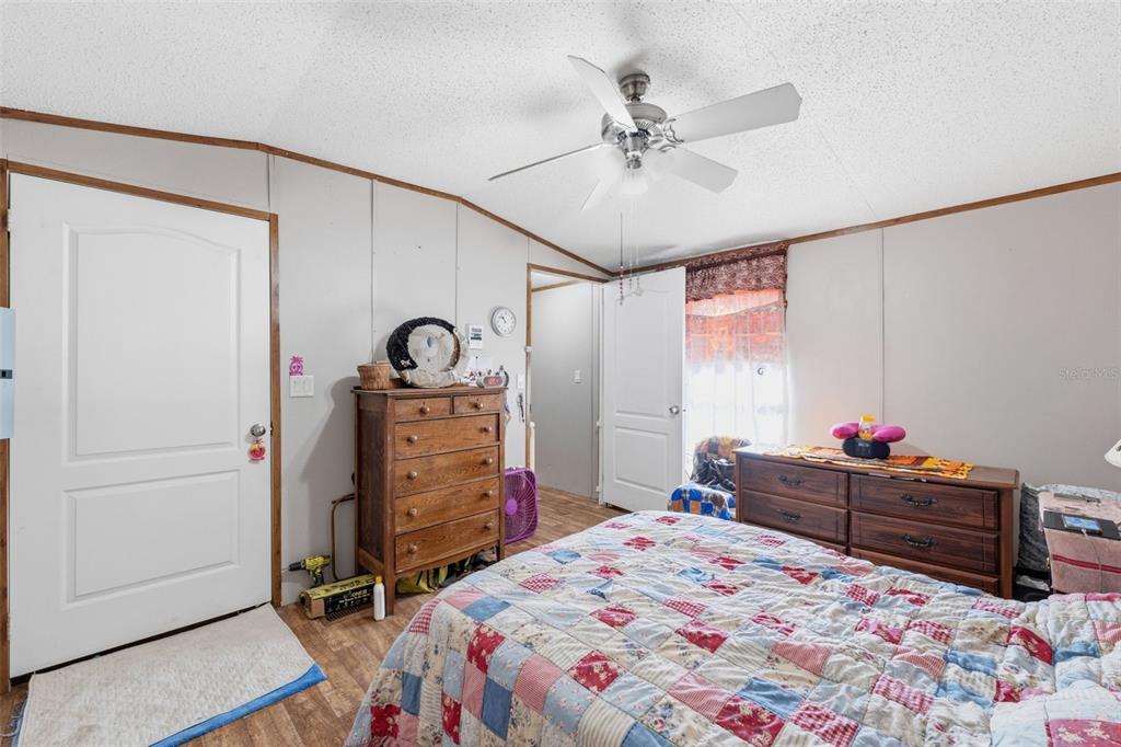 10501 East Patience Lane Inverness, FL 34450 - Photo 34 of 37 a bed room with a bed and a dresser