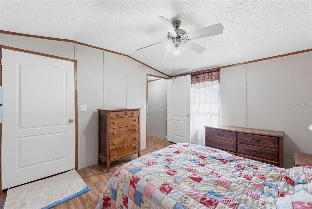 10501 East Patience Lane Inverness, FL 34450 - Photo 35 of 37 a bedroom with a bed and a dresser in it