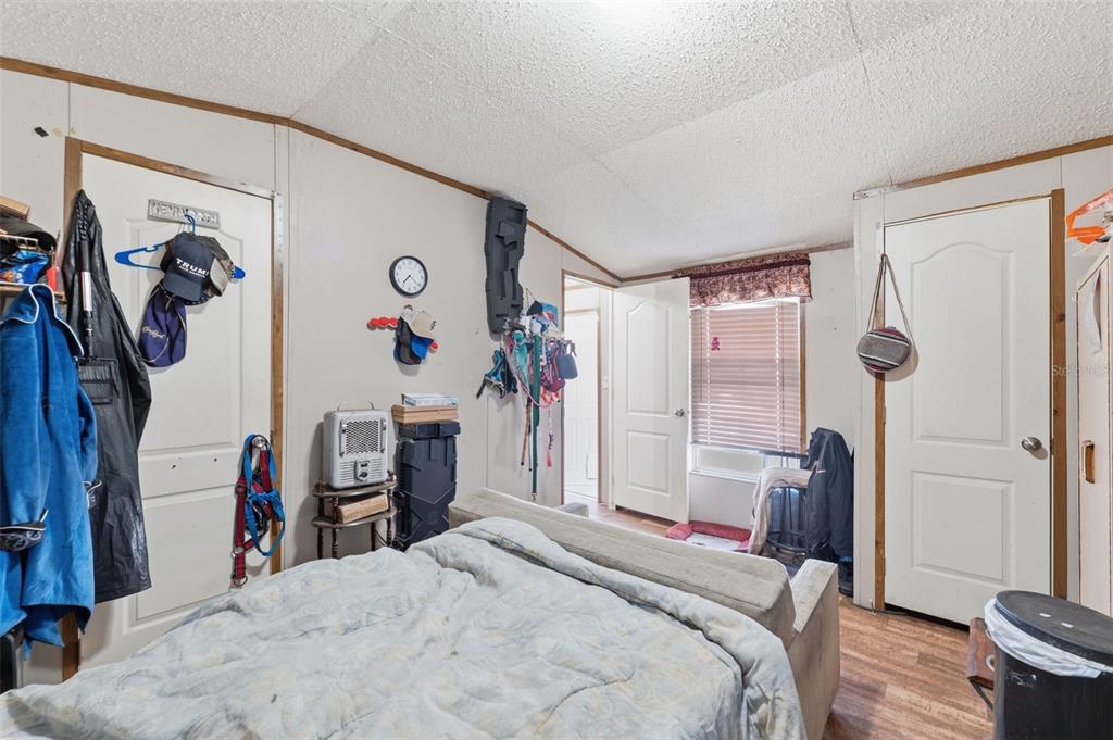 10501 East Patience Lane Inverness, FL 34450 - Photo 36 of 37 a bedroom with a bed and a walk in closet