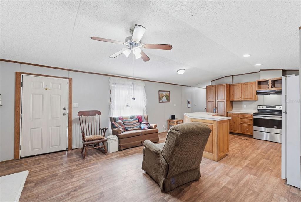 10501 East Patience Lane Inverness, FL 34450 - Photo 5 of 37 a living room with furniture kitchen and a wooden floor