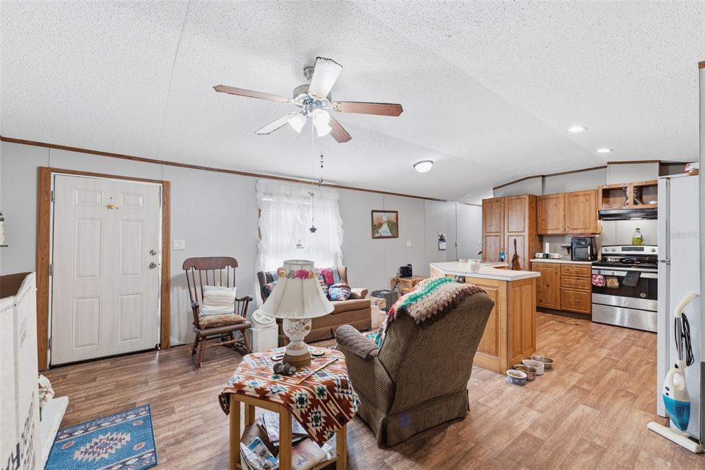 10501 East Patience Lane Inverness, FL 34450 - Photo 6 of 37 a living room with furniture kitchen view and a wooden floor