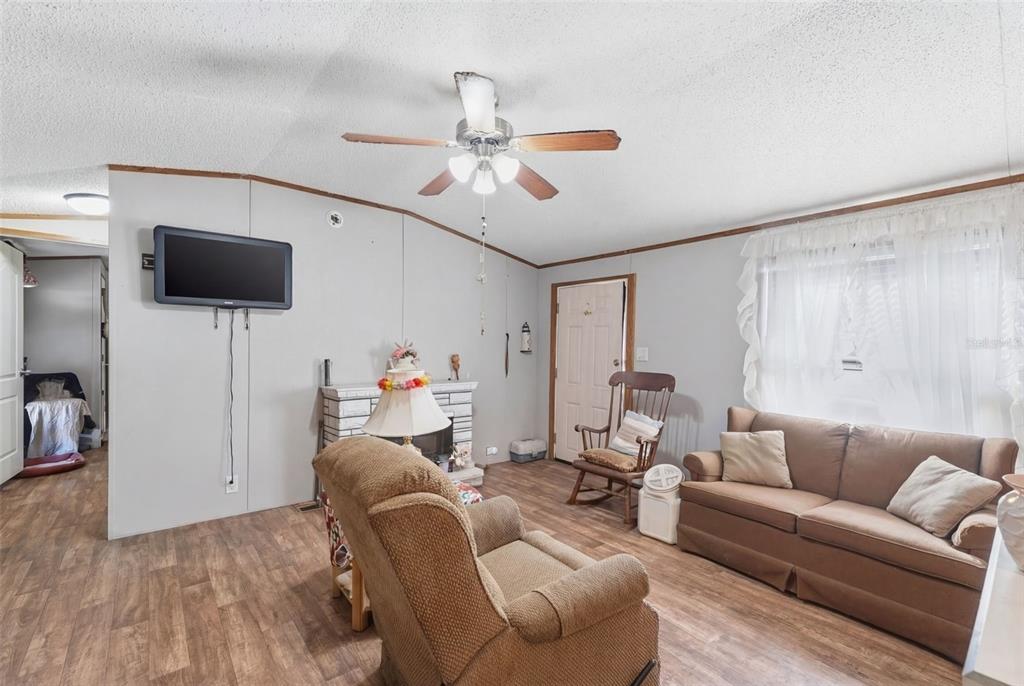 10501 East Patience Lane Inverness, FL 34450 - Photo 7 of 37 a living room with furniture and a flat screen tv
