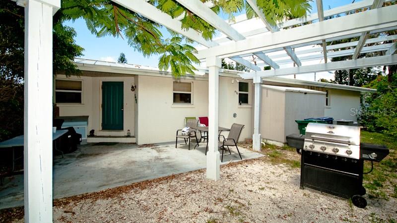 770 Jacaranda Road Anna Maria, FL 34216 - Photo 1 of 1 a view of a dinning table and chairs in the patio