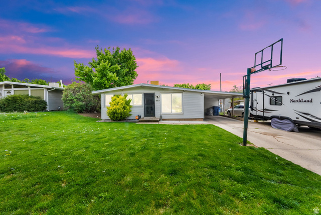 993 Rancho Boulevard Ogden, UT 84404 - Photo 1 of 1 View of front of house with an attached carport, driveway, and a lawn
