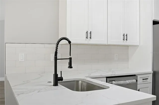 a kitchen with stainless steel appliances granite countertop a stove and a refrigerator