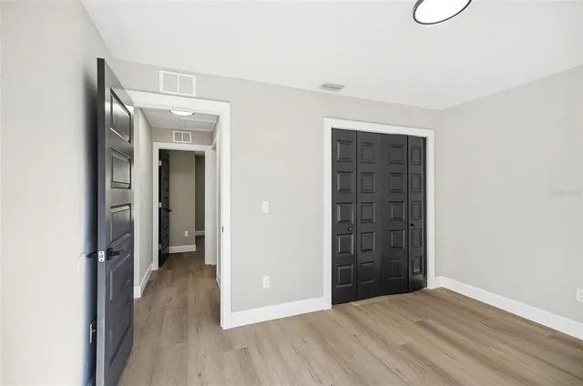 a view of a room with wooden floor and windows