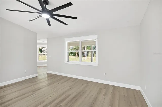 wooden floor in an empty room with a window