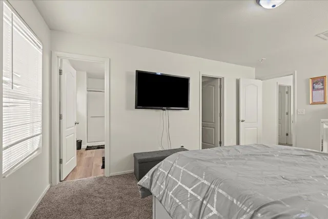 a bathroom with a sink a toilet a mirror and shower