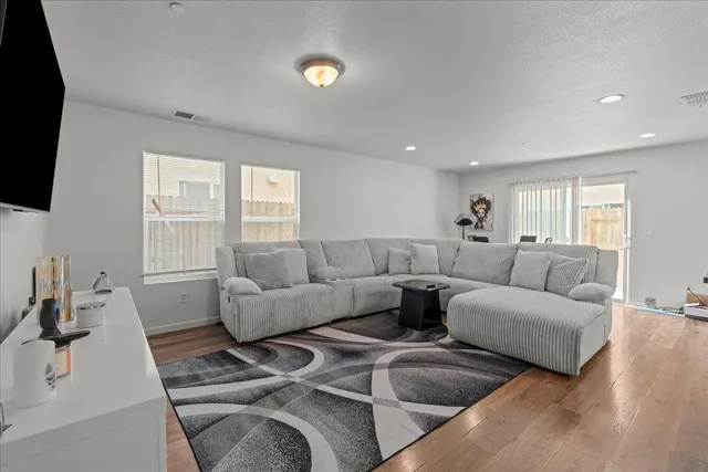 a living room with furniture a flat screen tv and a fireplace