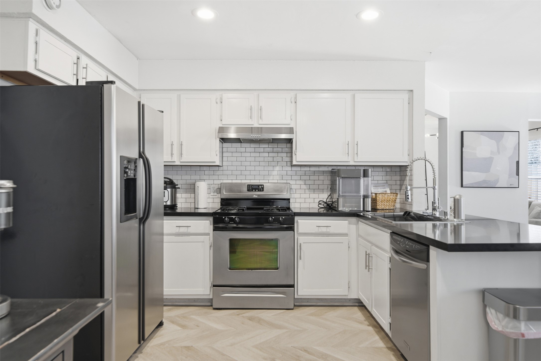 12906 Humphrey Drive Austin, TX 78729 - Photo 11 of 40 a kitchen with a stove a refrigerator and a sink