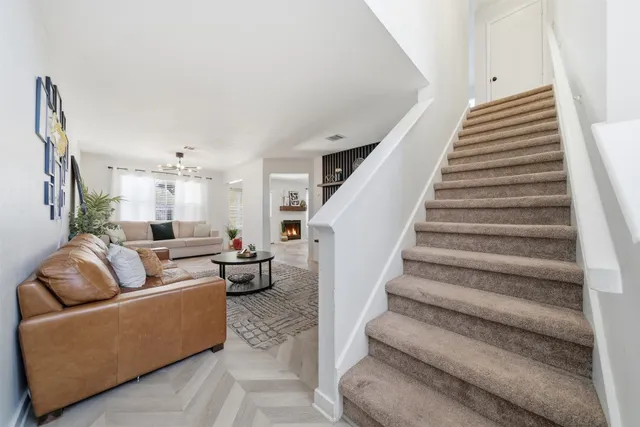 a living room with furniture and stairs