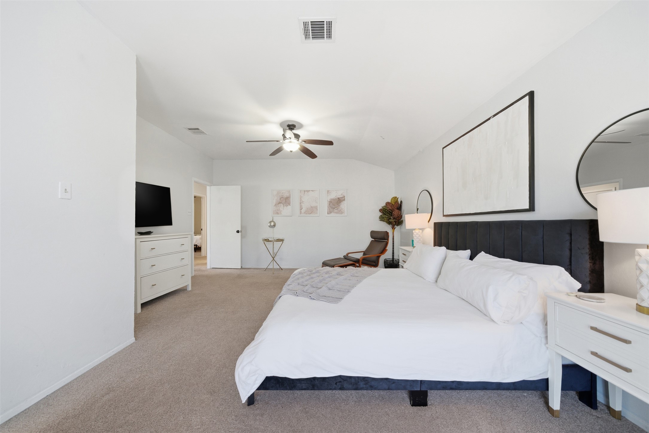 12906 Humphrey Drive Austin, TX 78729 - Photo 18 of 40 a bedroom with a bed and a flat screen tv