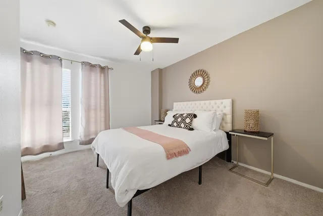 a bedroom with a large bed and a chandelier