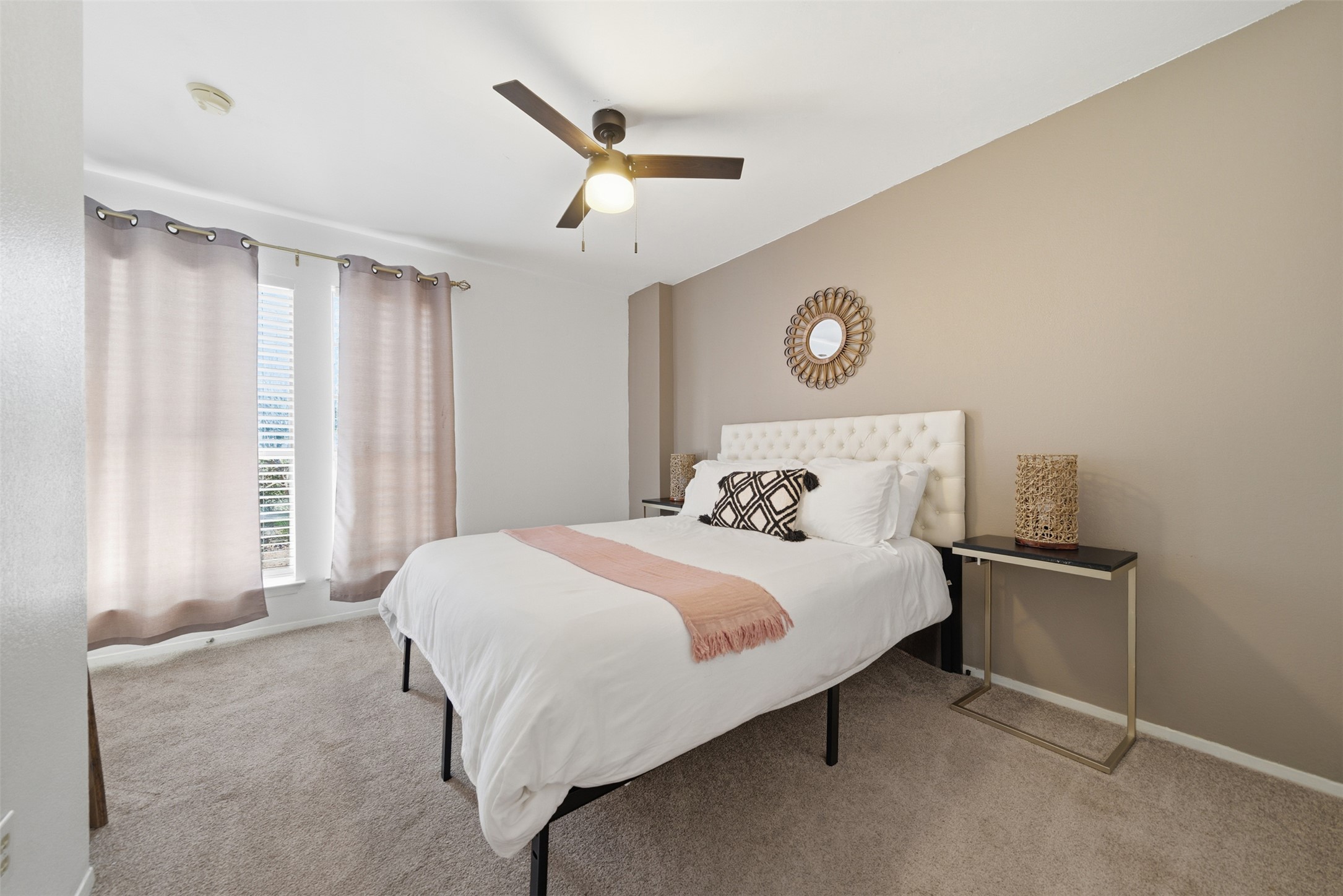 12906 Humphrey Drive Austin, TX 78729 - Photo 19 of 40 a bedroom with a large bed and a chandelier