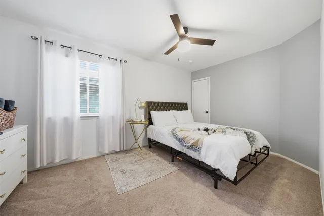 a bedroom with a bed and window