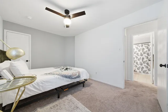 a bedroom with a bed and cabinets