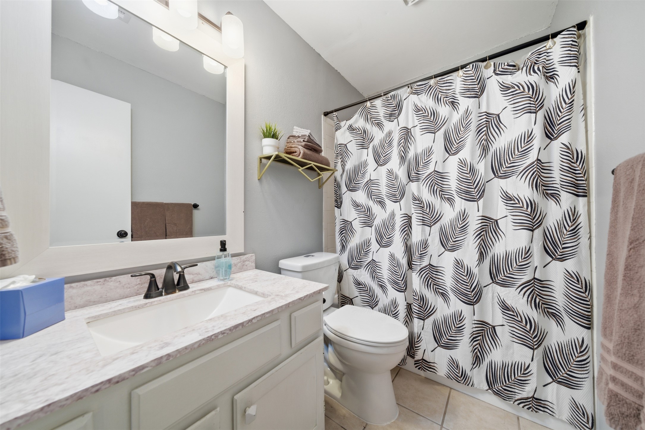 12906 Humphrey Drive Austin, TX 78729 - Photo 23 of 40 a bathroom with a granite countertop sink and a mirror