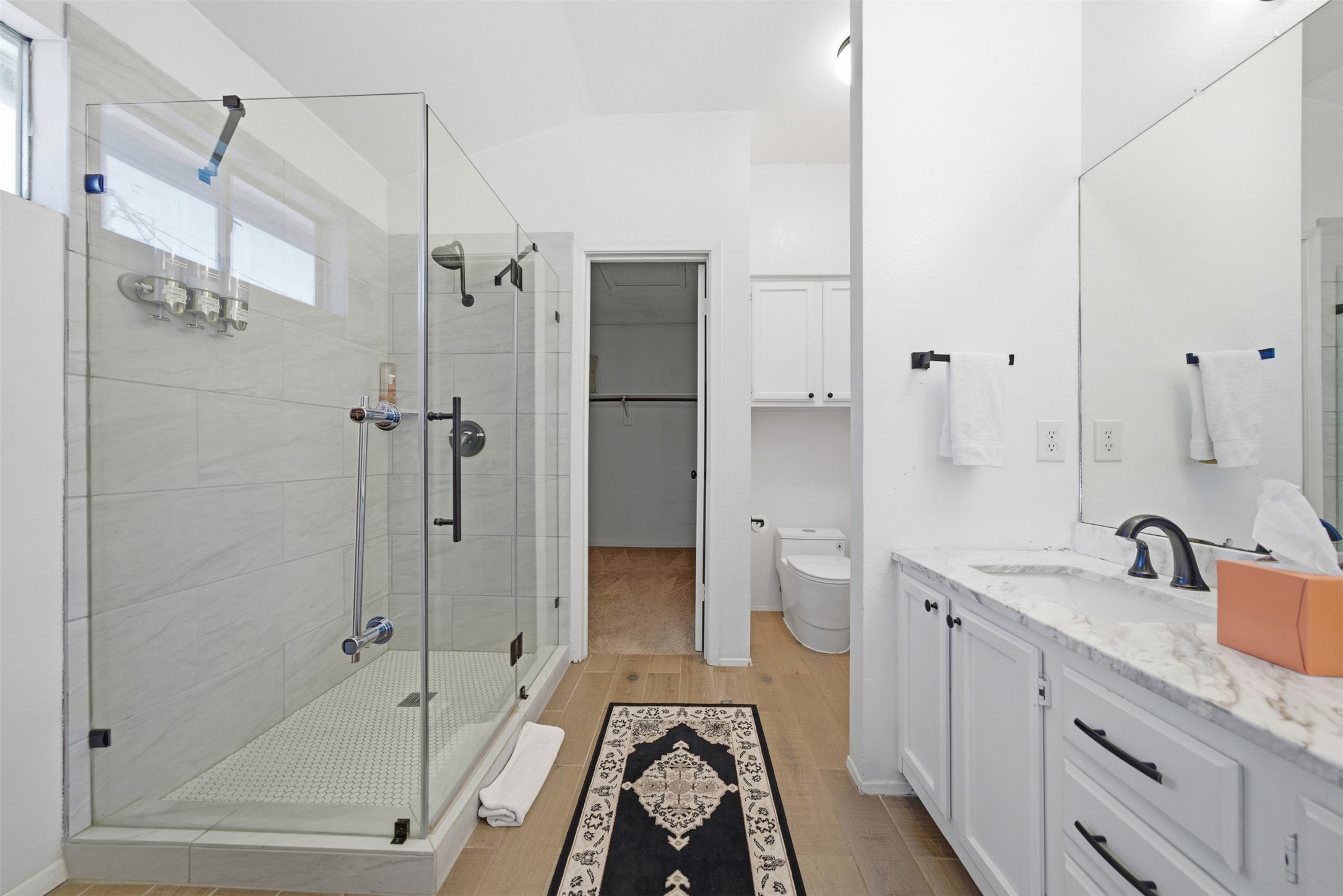 12906 Humphrey Drive Austin, TX 78729 - Photo 24 of 40 a bathroom with a granite countertop sink mirror bathtub and shower
