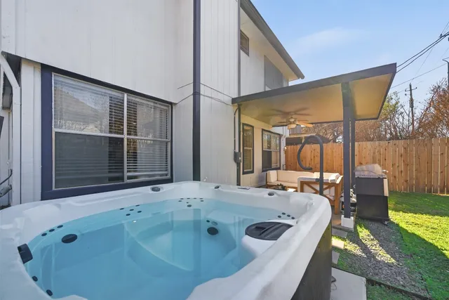 a bathroom with a tub sink and mirror