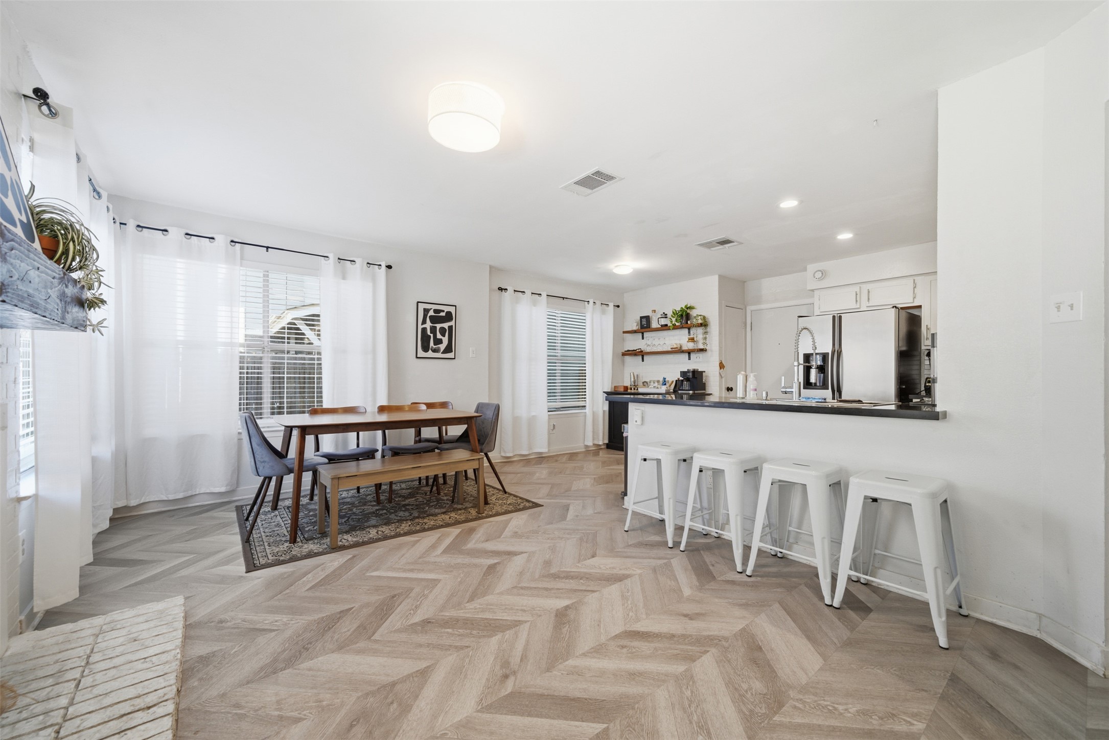 12906 Humphrey Drive Austin, TX 78729 - Photo 9 of 40 a kitchen with white cabinets and chairs