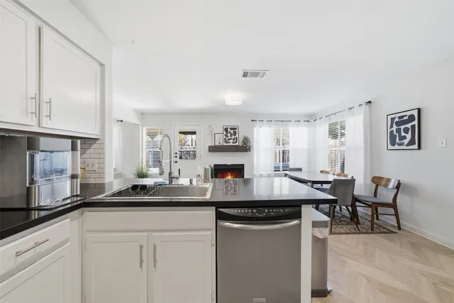 a kitchen with stainless steel appliances granite countertop a stove and a sink