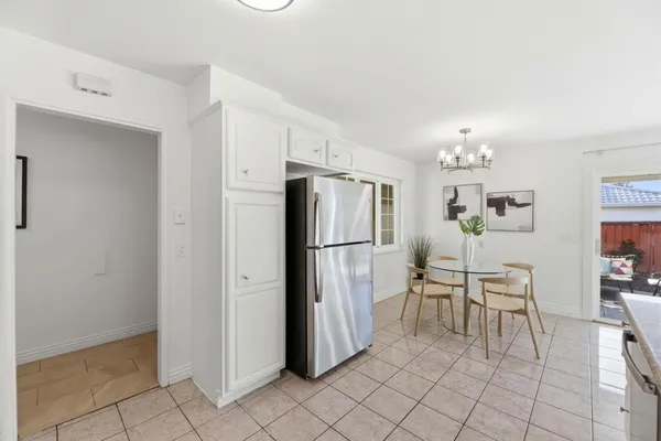 a kitchen with stainless steel appliances a refrigerator and a stove top oven