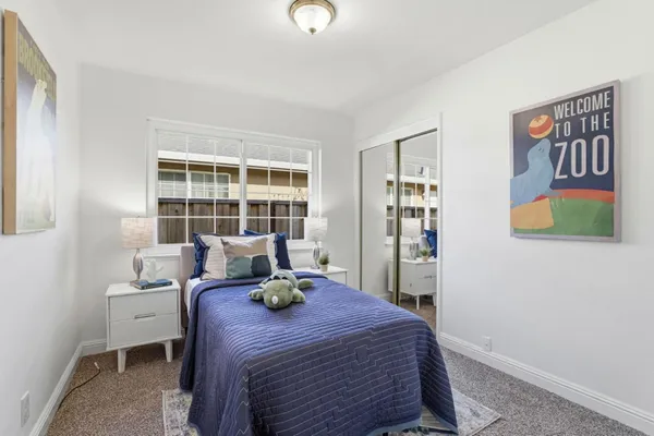 a bed room with a bed and a window