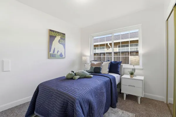 a bedroom with a bed and a window