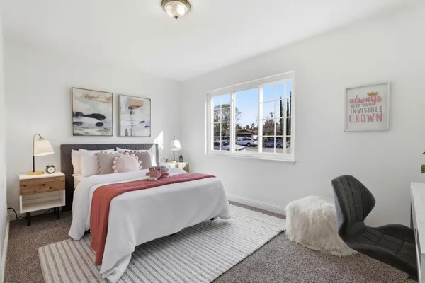 a bed room with a bed and a chair