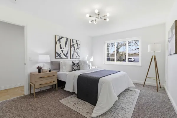 a bedroom with a bed and a night stand