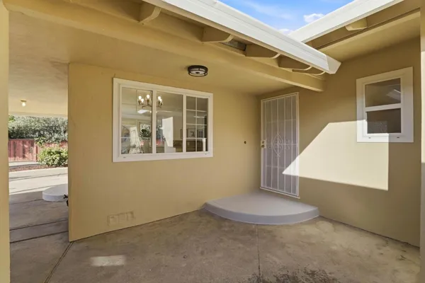 a view of a big room with wooden floor and windows